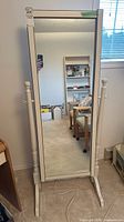 Front view of full-length standing floor mirror with white frame, showing overall shape and size.