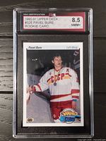 Front of the 1990-91 Upper Deck Pavel Bure rookie card in protective case showing player in CCCP uniform with Young Guns logo and grade 8.5 NMM+ by KSA.