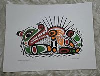 Full view of the signed Indigenous art print showing the otter design and sea urchin elements in black, green, orange, and red.