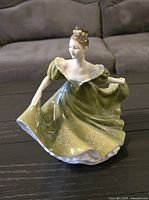 Front view of the Royal Doulton Lynne figurine showcasing the detailed green dress and pose.