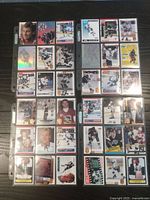 Top view of 36 Wayne Gretzky hockey cards arranged in three sheets, displayed on wooden surface.