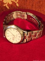 Side view of vintage Seiko mechanical watch showing stainless steel band and silver-tone case with wear marks.