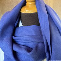 Close-up of the royal blue pashmina shawl on a mannequin, showing fabric texture and color.