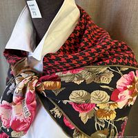 Scarf draped around neckline showing floral design with visible Bill Blass branding.