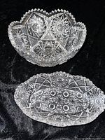 Top view of the cut glass bowl and relish dish showing intricate cut patterns and scalloped edges on a black background