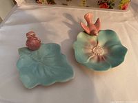 Photo of 2 Royal Copley bird trinket dishes, view showing leaf shapes and perched pink birds.