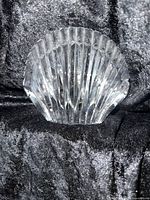 Front view of clear Waterford crystal shell figurine with beveled design placed on black velvet background