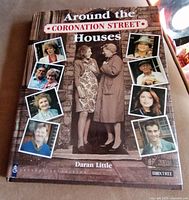 Front cover of the hardcover book 'Around the Coronation Street Houses' featuring images of characters from the Coronation Street TV series.