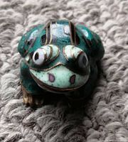 Front view of the small gold and turquoise cloisonné frog figurine showing intricate raised texture and detailed eyes.