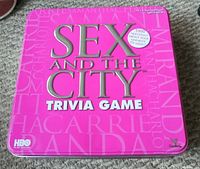 Top lid of the Sex And The City Trivia Game featuring the title and branding in hot pink and silver.