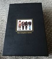 Black collector's box for Seinfeld The Complete Series showing cover art of four characters bowing.