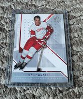 Front of Gordie Howe hockey card in protective sleeve, showing player image, team, and series information