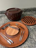 Photo showing all items arranged on teak tray with cast iron pot, trays, utensils, and trivet visible