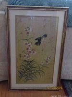 Full view of the framed Chinese silk painting depicting a bird and flowers.