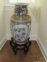 Full view of large Chinese porcelain floor vase on black lacquered wood stand.