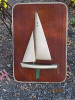 Full view of vintage wooden half hull sailboat model mounted on a wooden plaque with rounded edges. The plaque is about 13.5 x 19.5 inches in size. The model shows two sails marked 'C 92'.