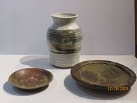 Lot consisting of vintage handmade ceramic vase and two pottery bowls showing overall shape and color.