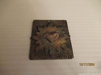 Comstock sterling silver pendant featuring embossed heart and sunburst design, front view showing detailed textured silverwork.