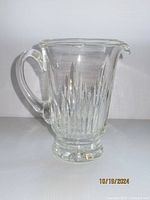 Side view of clear Waterford Crystal Eileen pitcher with handle and vertical cut crystal detail showing the spout and base