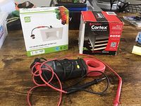 Lot showing Gardner Bender clamp meter with test leads laid out in front of boxed ASD LED square downlight retrofit kit and Cortex hidden fastening system.