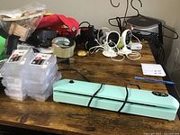Photo of the vacuum sealer on wooden table along with power cord and other small items