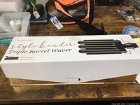 Box of TruBeauty Style Bender Triple Barrel Waver with product name and image of the tool on top.