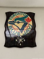 Front view of 1990s Toronto Blue Jays wood wall clock showing team logo and clock face