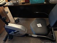 Side view of Marcy recumbent stationary bike showing padded seat and reclined position.