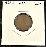 Obverse view of 1922D Lincoln penny showing Abraham Lincoln profile and coin holder with handwritten date and condition