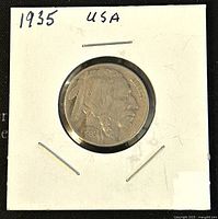 Front side of the 1935 Buffalo Nickel showing the Native American profile and the date 1935.