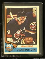 Front side of 1974-75 O-Pee-Chee Jean Potvin New York Islanders hockey card showing player image, team logo, and name