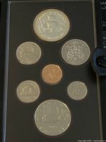 Photo showing seven Canadian coins from 1979 in a protective holder, highlighted by a large silver double dollar coin with Viking ship design and other smaller coins with various national symbols.