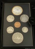 Frontal view of the 1981 Canadian Proof Coin Set with obverse showing Queen Elizabeth II on seven coins including a large double dollar and smaller denominations in a protective case.
