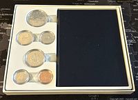 Full view of the 6-coin set in white holder with black section on right.
