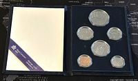 Open coin set presentation case showing 6 Canadian coins in holders with protective foam in blue case