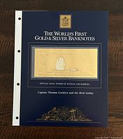 Official presentation folder for the gold and silver banknote titled 'The World's First Gold & Silver Banknotes' featuring Captain Thomas Cocklyn and the Bird Galley