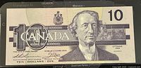 Front of the banknote showing portrait of Sir John A. Macdonald and '10 Canada' text with signatures and 'Ottawa 1989' marking.