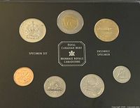 Seven Canadian specimen coins displayed in black holder marked 'Specimen Set', 'Royal Canadian Mint', and 'Ensemble Specimen', showing detailed coin faces including coat of arms, polar bear, and other images.