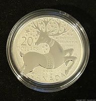 Obverse showing the happy reindeer design, with denomination and silver purity markings.