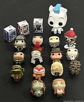 All 18 Funko Pocket / Bitty POP! vinyl collectible figures arranged on surface, including one large figure head and small boxed figures