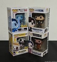 Stacked Funko POP! boxes showing all four collectible figures with branding and characters visible.