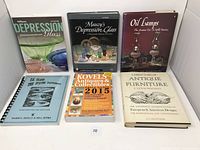 Photo of six collector books on a white background, including titles on Depression glass, oil lamps, collectibles, quilt patterns, and antique furniture.