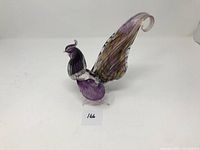 Side view of signed art glass rooster showing curved tail and detailed body.