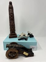Full view of all items including wooden totem, skull, and three mini cannons on display box