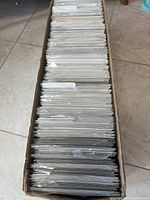 Top view of the box filled with plastic-sleeved comic books, showing condition and quantity.
