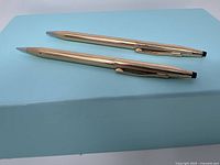 Set of two Cross pen and pencil on a light blue surface