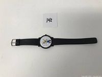 Full view of the Disney Goofy watch laid flat, showing black strap and dial with Goofy illustration.