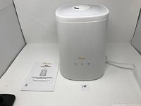 White Crane ultrasonic humidifier with top fill water tank and control buttons visible. Power cord partially visible.