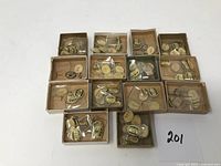 Photo of 14 small cardboard boxes, each containing multiple vintage watch crystals in individual plastic bags with labels.