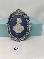 Front view of Lord Nelson relief hanging porcelain plaque on blue background